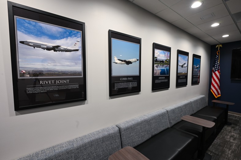 Calvert office hallway with mission aircraft displays and an American flag