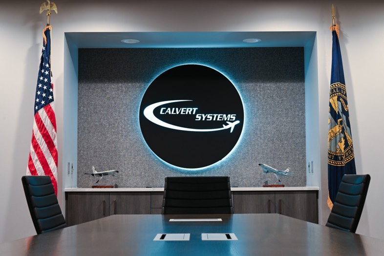 Calvert conference room with company branding and flags